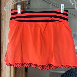 Lululemon Pace Setter Skirt. Bright orange and inkwell sea stripe. Size 2
